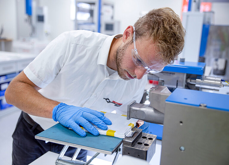 Colleague conducts welding tests on a battery cell