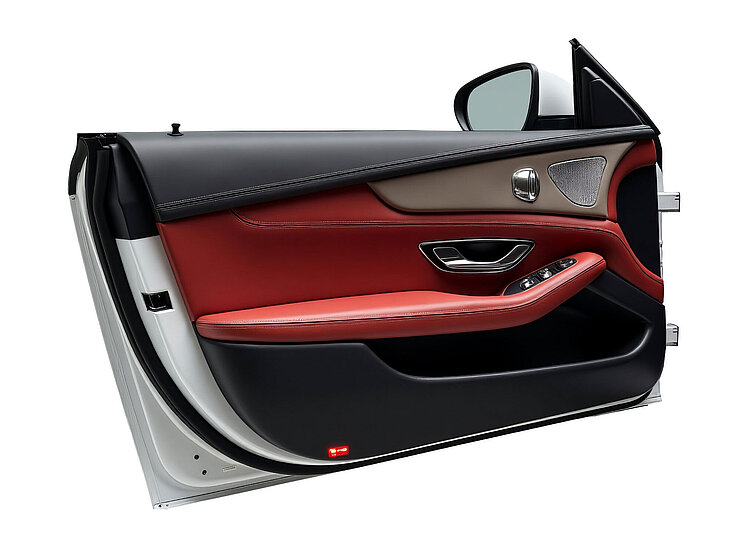 Car door interior with black and red leather and integrated control elements