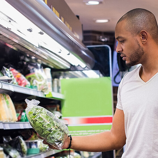 Person looking at food in a supermarket